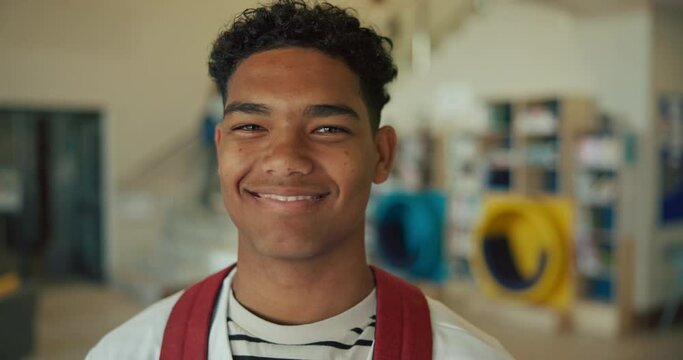 Smile, high school and portrait of boy teenager with backpack for education, growth and development on campus. Happy, face and student in lobby of learning academy with confidence, pride or knowledge