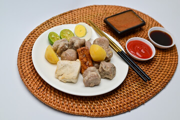 Siomay, a traditional Bandung dish, is a steamed dumpling made from mackerel fish and flour. It’s served with a rich peanut sauce, soy sauce, and chili sauce, offering a flavorful Indonesian culinary 