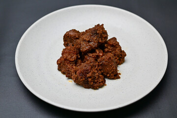 Asian Food Rendang is a rich and tender coconut beef stew from Indonesia, known for its slow-cooked process and complex flavors of coconut milk, lemongrass, and spices. It's a celebrated dish globally