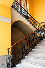 Colonial staircase with stained glass background and bottom-up focal point