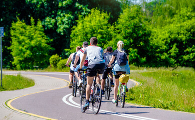 Cyclists ride on the bike path in the city Park