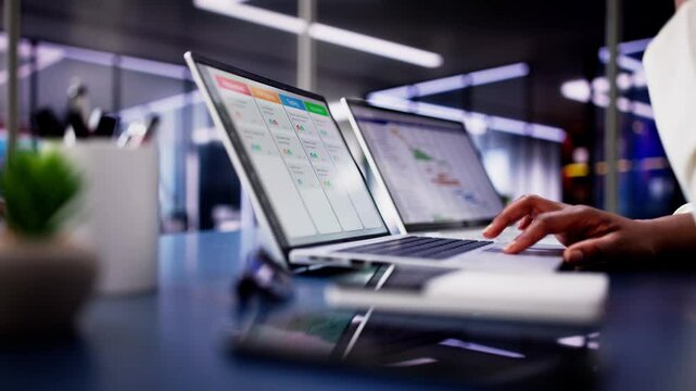 Focused African American woman using laptop to manage business schedule