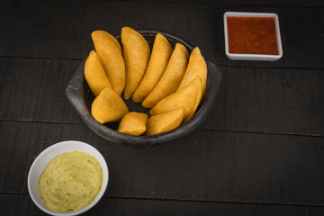 Colombian empanada with spicy sauce 