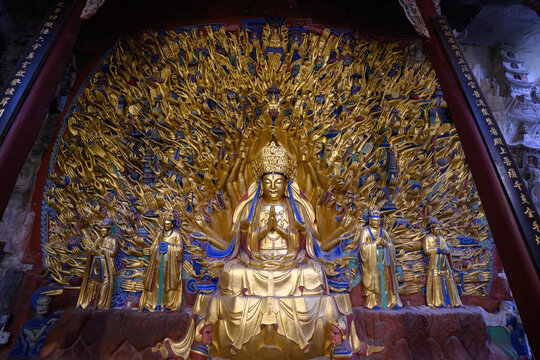 Golden sculpture of Guanyin with thousand hands at Dazu Rock Carvings at Mount Baoding or Baodingshan in Chongqing, China. UNESCO World Heritage.