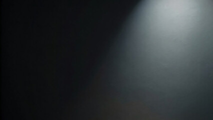 A dark theater stage bathed in a spotlight's glow, revealing a smooth, brushed metal surface