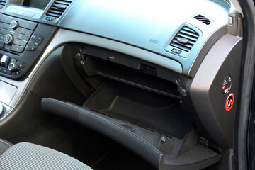 Open glove compartment in car. Modern car passenger airbag. Glove compartment in white car interior. Detail of modern car interior. 