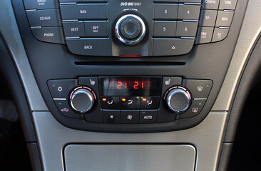 Car climate control. Modern car climate control. Close-up detail with the air conditioning panel inside a car. Turning on the air conditioning of on the climate control. Modern car interior.
