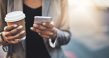 Business woman, latte and hands with phone in city for communication, networking and social media. Female person, coffee and travel with smartphone to work for email, clients and app while trading