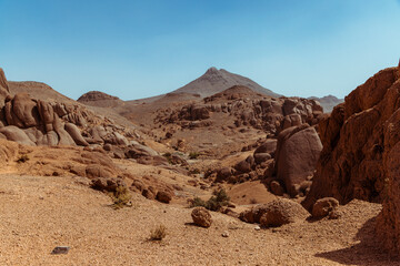 Rocky valley in the Sahara desert and a blue sky