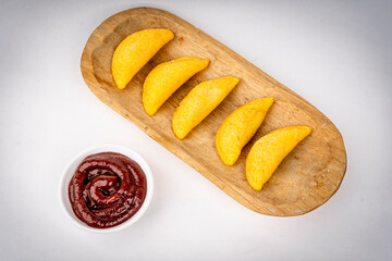 Colombian empanada with spicy sauce 