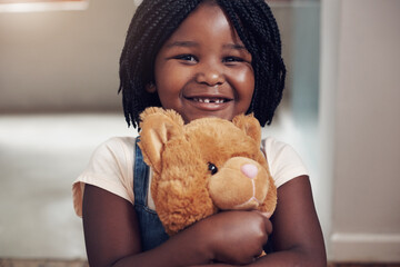 Smile, portrait and black child in home with teddy bear, hug and playful with toy with happiness....