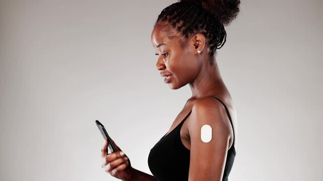 Medical Technician Monitoring Patient's Glucose Levels Using Smart Phone App