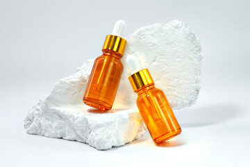 Dropper bottle on white stone. Serum bottle for mockup.
