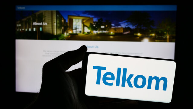 Stuttgart, Germany - 06-11-2024: Person holding smartphone with logo of South African company Telkom SA SOC Limited in front of website. Focus on phone display.