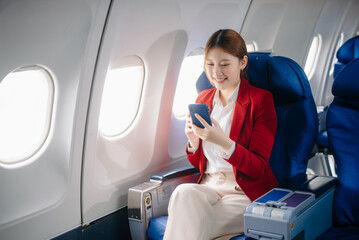 Asian Woman Working on Tablet During  in first class, multitasking with Flight Travel in style, work