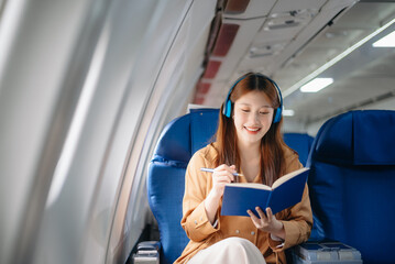 Asian Woman Working on Tablet During  in first class, multitasking with Flight Travel in style, work