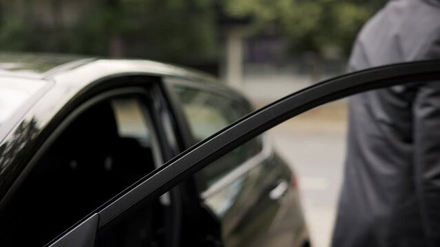 Woman's Hand Giving Car Key To Male Valet