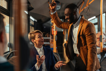 Business professionals conversing on a bus