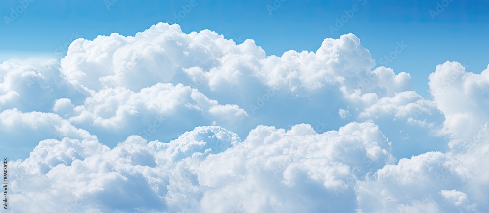 Aufkleber Soft-focused white clouds against a blue sky background with ample copy space image in a horizontal layout.