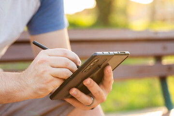 person writing on foldable phone with stylus