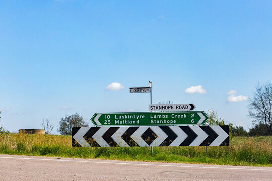 Road sign with t intersection and directions to Maitland and Stanhope