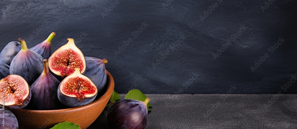 Aufkleber top view of fresh figs in a wooden bowl on a stone table with a dark background, ideal for copy spac