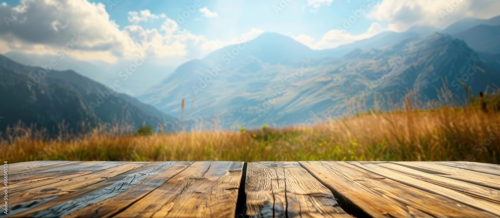 Aufkleber a wooden table top set against a blurry mountain and grass field backdrop, evoking a sense of freshn