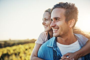 Couple, piggyback and outdoor in nature on farm for rural life, agriculture and sustainable farming for agro industry. Man, woman and together with love on green land, countryside and commitment.