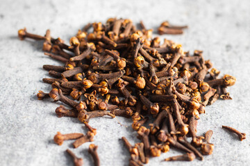 selective focus of Laung Clove, Indian spice with ceramic background. 