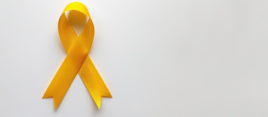 Commemorate Childhood Cancer Day with a yellow ribbon set against a white backdrop, perfect for inclusion in a layout with copy space image.