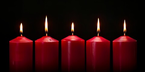 Five burning red candles on black background, symbolizing hope, remembrance, or celebration