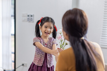 Fototapeta premium cheerful asian toddler daughter hugging happy mother Good time at home.