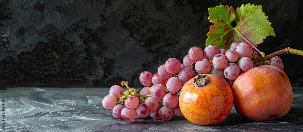 Aufkleber ripe pink grapes and a persimmon isolated on black background with copy space image.