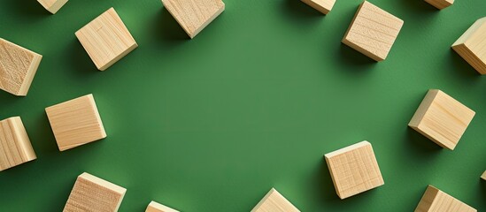 Wooden cube blocks arranged on a green summer backdrop with a blank space for inserting an image. with copy space image. Place for adding text or design