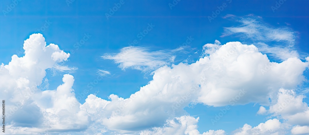 Aufkleber Soft-focused white clouds against a blue sky background with ample copy space image in a horizontal layout.