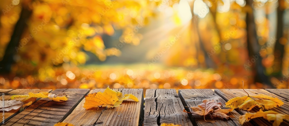 Poster a conceptual photo with a wooden table showcasing yellow tree leaves, symbolizing the changing seaso