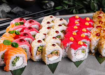 Assorted sushi platter on dark stone background