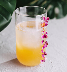 Tropical cocktail with orchid garnish