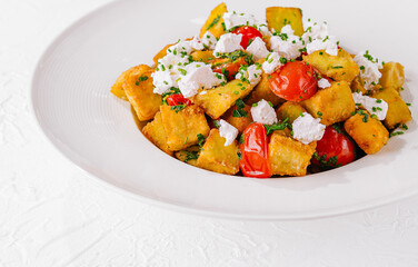 Fresh homemade polenta with tomatoes and feta