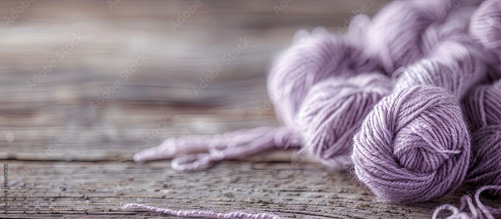 Aufkleber Engaging in knitting as a hobby with a background of a skein of pale lilac wool thread on a wooden table creates a serene and inviting atmosphere for a copy space image.