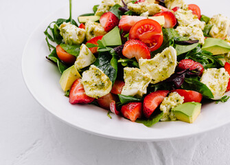 Fresh mixed salad with avocado and strawberries