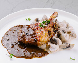 Gourmet pork chop with mushroom sauce on plate