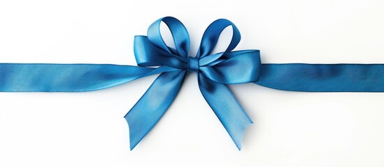 Close-up top view shot of a solitary horizontal blue ribbon with a bow set against a white...