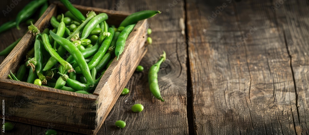 Poster fresh organic green common beans or kidney beans in a wooden box for cooking, set against a wooden b