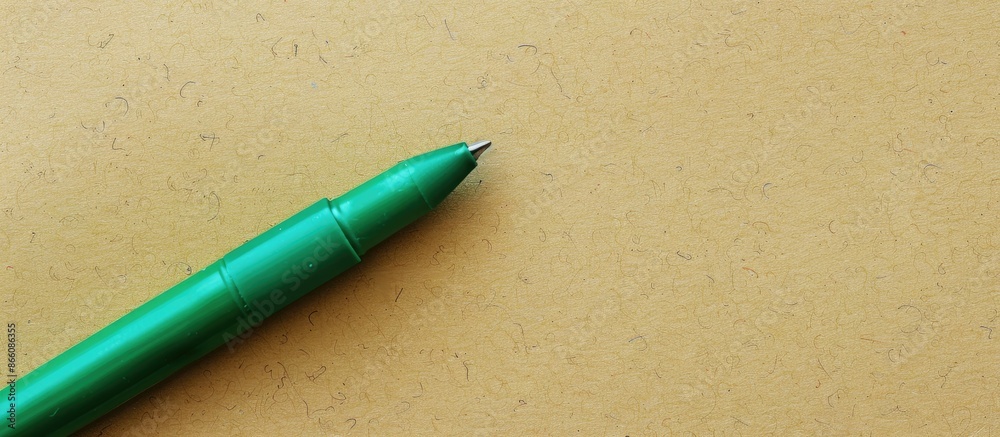 Aufkleber green marker pen is writing on paper with ample copy space image for text or graphic design.