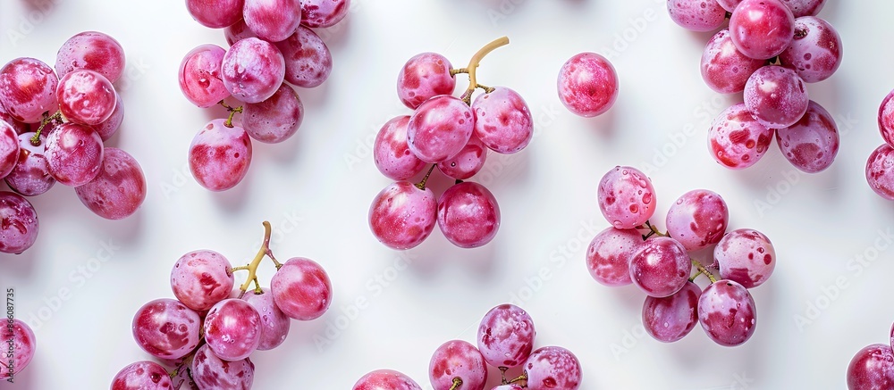 Poster Pink grapes isolated on a white background with ample copy space image for text. View from above in a flat lay pattern.