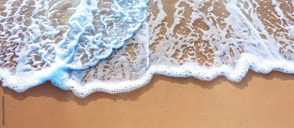 Aufkleber a gentle wave gently rolls onto the sandy beach in the summertime, providing a serene backdrop for s