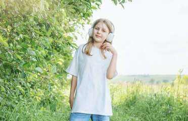 A child  with headphones listening to music and dancing