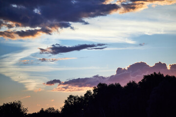 beautiful lilac sunset with clouds on the riverbank