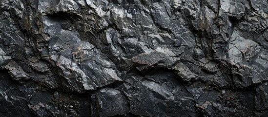 Dark rock texture on a black grunge background, suitable for a copy space image.